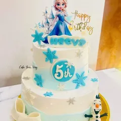 A frosty and fabulous Frozen-themed cake for a 5th birthday. This two-tier design features Elsa, a fondant Olaf, and delicate snowflake details for a true winter wonderland feel.
