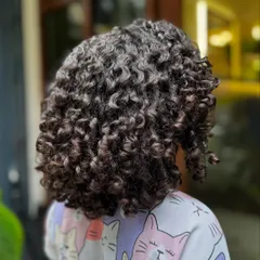 Born to be wild and curly! This little one got a fresh cut to shape her beautiful curls, making them bouncy, healthy, and easy for her parents to manage.