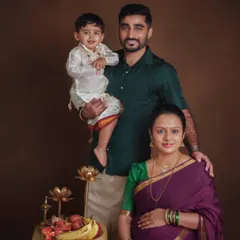 A classic family portrait celebrating the upcoming arrival. The family is dressed in traditional South Indian attire, creating a beautiful and formal portrait that honors their heritage while looking forward to their new beginning.
