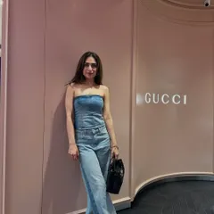 This denim-on-denim outfit with a corset top and wide-leg jeans was too good not to share. Here I am at the Gucci store, feeling the look.