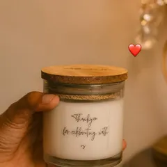 A candle perfect for all occasions. This simple glass jar candle with a wooden lid says 'Thank you for celebrating with us,' a small token of love for the people who matter.
