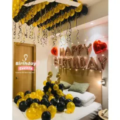 Another popular bedroom setup, this time with black and yellow balloons covering the bed and ceiling for a 23rd birthday.