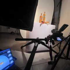 This is the setup for the "liquid gold" Johnnie Walker shot. You can see the large softbox creating the clean white background and the precise placement of the bottles. My laptop shows the tethered image, which is crucial for getting the composition just right.