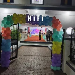 This colorful balloon arch frames the entrance to a banquet hall for a butterfly-themed birthday party. The setup includes a welcome sign and my branded 'HIFI CREATIONS' lightbox, guiding guests into the celebration.