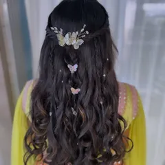 A whimsical and pretty hairstyle for a fun event. I created soft waves and adorned them with delicate butterfly clips for a touch of magic.
