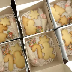 A peek inside my Christmas cookie decorating kits, all boxed up and ready for a party. Each box contains plain cookies in festive shapes, bags of colorful icing, and of course, plenty of sprinkles.
