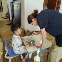 There is nothing more heartwarming than seeing a parent and child creating something together. This little one is getting some help building his very own terrarium, a perfect activity for family bonding and making memories.