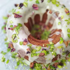 A full view of my beautiful Gulab Jamun Cake, decorated with a lovely white glaze, chopped pistachios, and delicate rose petals. This fusion dessert is perfect for birthdays, anniversaries, or any festive gathering.