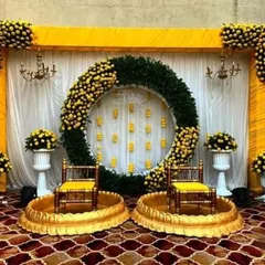 I love creating vibrant and grand setups for Haldi ceremonies. This design uses a massive ring of marigolds and lush greens to create a spectacular focal point for your celebration.