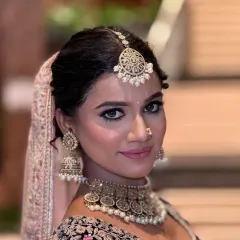 A stunning portrait for an engagement or reception. The makeup features a soft smokey eye and a subtle pink lip, creating a look that is both glamorous and elegant.