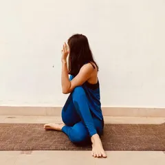 This is Ardha Matsyendrasana, a seated spinal twist that is wonderful for stimulating digestion and energizing the spine. It also provides a deep stretch for the shoulders, hips, and neck, helping to relieve backache and fatigue. I always offer modifications to make it accessible for everyone.