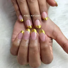 Clean and sharp. A classic French manicure gets a modern upgrade with a bold, reflective gold chrome tip.