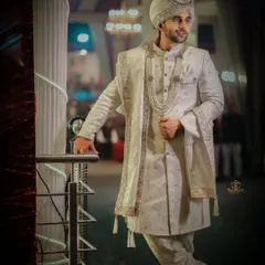A stylish, full-length portrait of the groom. We used creative lighting to create a vignette effect, making him the sole focus of this powerful image.