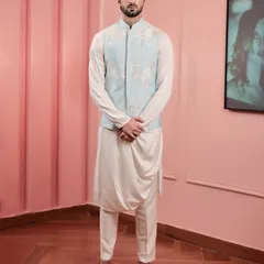 This look showcases modern festive wear. We paired a powder blue bandi jacket, detailed with delicate floral embroidery, with a contemporary draped kurta to create an outfit that is both elegant and effortlessly stylish for daytime events.