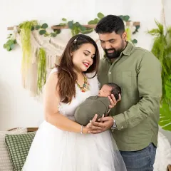 From maternity to newborn. We were so happy to capture this family's complete journey, seen here admiring their new baby in our lush, green boho setup.