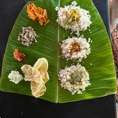 A simple, nourishing satvic meal served on a traditional banana leaf. Food is an essential part of our wellness journey, prepared with love to support your body and soul.