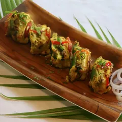 Experience a burst of flavor with our Paneer Bharwan Tikka. Each piece of paneer is stuffed with a savory filling and grilled, creating a multi-layered taste experience.