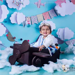 Ready for takeoff. In this pilot-themed shoot, this happy baby is flying high above the clouds in his own vintage airplane, complete with an aviator cap and goggles.