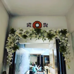Even simple home celebrations deserve a special touch. We designed this lush floral arch to frame the doorway of a home, creating a festive atmosphere for a family gathering.