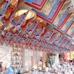 For a "St. Tropez" themed event, we transformed the ceiling with a vibrant installation of custom-printed scarves. This overhead decor element added color, pattern, and a sense of breezy, Mediterranean luxury to the entire space.