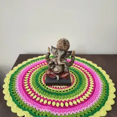 Here, the mandala serves as a decorative mat for a Ganesha statue, adding a vibrant splash of color. Mandalas are meditative projects, perfect for practicing mindfulness through crochet.