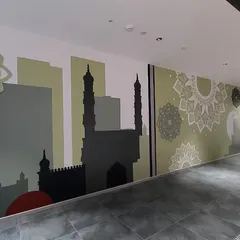A wide shot of the Hyderabad-themed abstract wall mural. This multimedia piece uses silhouettes of famous landmarks and decorative patterns to create a modern and stylish tribute to the city's culture and history.