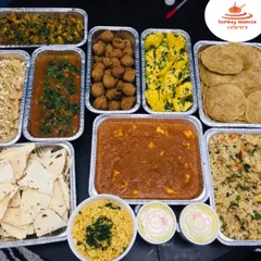 Our bulk food delivery service brings the feast directly to you. This spread, featuring Paneer Butter Masala, Dal, Puris, and more, is perfect for house parties, society events, or any large gathering where great food is a must.