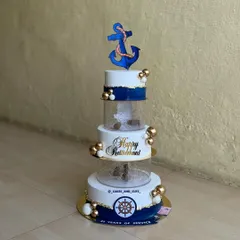 We were honored to create this special five-tier retirement cake for a Navy officer. The design incorporates a nautical theme with an anchor topper, a ship's wheel, and clear acrylic tiers filled with fairy lights for a beautiful glow.