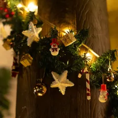 The festive spirit is in every detail. Our wooden pillars are decorated with garlands, twinkling lights, and charming ornaments like snowmen and candy canes for the holiday season.