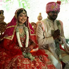 The couple seated during their wedding ceremony, surrounded by tradition and the love of their families. We work to create a setting that honors these timeless rituals.