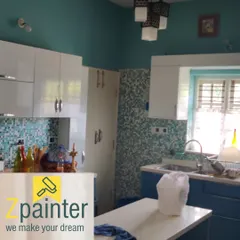 A kitchen with teal walls and a blue and white mosaic tile backsplash. The wall color was chosen to perfectly match the vibrant tiles.