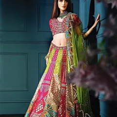 A full-length shot of a vibrant, multi-colored lehenga, perfect for a festive collection. I used lighting to make the colors pop against the dark background, showing the entire outfit in its best light for e-commerce or social media.