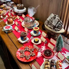 A closer look at our Christmas market stall, showcasing the variety we offer. From gingerbread cookies and eclairs to our large gingerbread house, we have something for every sweet tooth.