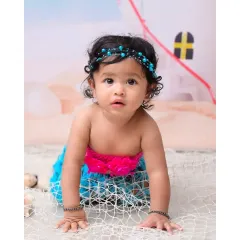 A close-up shot of the baby mermaid crawling towards the camera. This pose is perfect for sitter sessions, capturing that exciting milestone of newfound mobility.