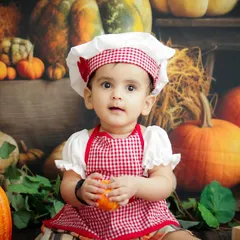 Our little pumpkin patch chef! This autumn-themed shoot with a chef's hat and apron is a fun way to celebrate the season.