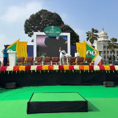 The main stage setup for the EV Expo, complete with an LED screen backdrop and floral decorations. We design and build stages that serve as a professional focal point for speakers and presentations.
