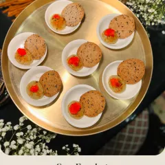 Sour Eggplant Ragi Crisps presented as individual portions. The tangy eggplant relish is paired with a crunchy, wholesome ragi crisp for a unique flavor combination.