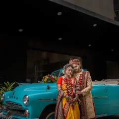 A classic portrait of a Maharashtrian couple with a vintage Dodge car, blending tradition with a touch of retro style for a unique wedding photo.