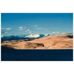 The stark beauty of the Ladakhi landscape near Tso Moriri, where the barren brown mountains meet the deep blue of the lake.
