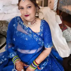It was a pleasure getting the groom's mother ready. Her vibrant blue outfit was paired with a classic makeup look, featuring a bold lip and defined eyes, and a traditional messy bun hairstyle.