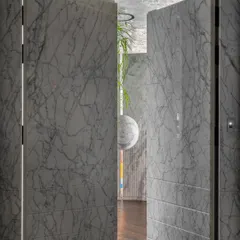 The entrance to the "Dream Project" features a door clad entirely in Grey Myst marble. It’s designed to be virtually invisible when closed, creating a seamless marble wall that makes a powerful first impression.
