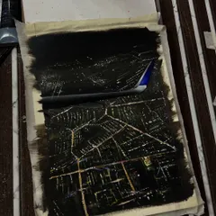 The painting in progress. I used a lot of black paint to create the night sky and then carefully added the glowing city grid.