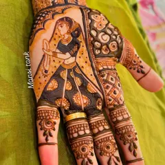 A close up of the bride figure from a wedding mehendi set. Notice the fine details in the jewelry, the expression, and the pattern on the lehenga.