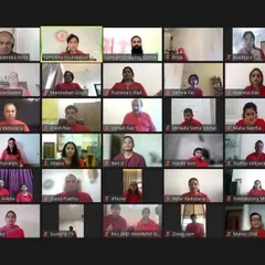 A grid view of participants dressed in red, fully engaged in our virtual workshop on prosperity. This image captures the collective energy and focus of the group during a guided meditation and healing session.