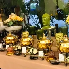 A detailed view of our buffet table, showcasing the ornate, polished golden serving dishes and thematic decor. We ensure every element of the display, from the serving spoons to the floral accents, is perfectly coordinated.