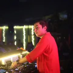 A side profile of me at the console during a Diwali party, surrounded by festive lights. I'm always in control of the music and the mood.