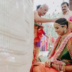 The bride being blessed during the ceremony. Her makeup is designed to be long-lasting and look beautiful from every angle.