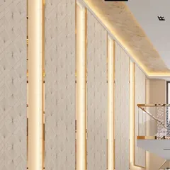 Detail of the backlit wall paneling with gold trim, adding a touch of luxury to the duplex apartment's double-height wall.