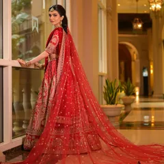 The drama of a long, embellished veil is unmatched. This shot captures the complete royal bridal look, from the intricate lehenga to the flowing dupatta, all tied together with makeup that enhances the bride's natural elegance.