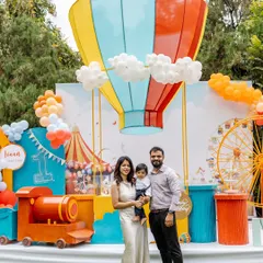 Step right up to a spectacular carnival adventure. We brought this first birthday party to life with a giant hot air balloon backdrop, a custom train, and a vibrant ferris wheel, creating a playground of fun for everyone.